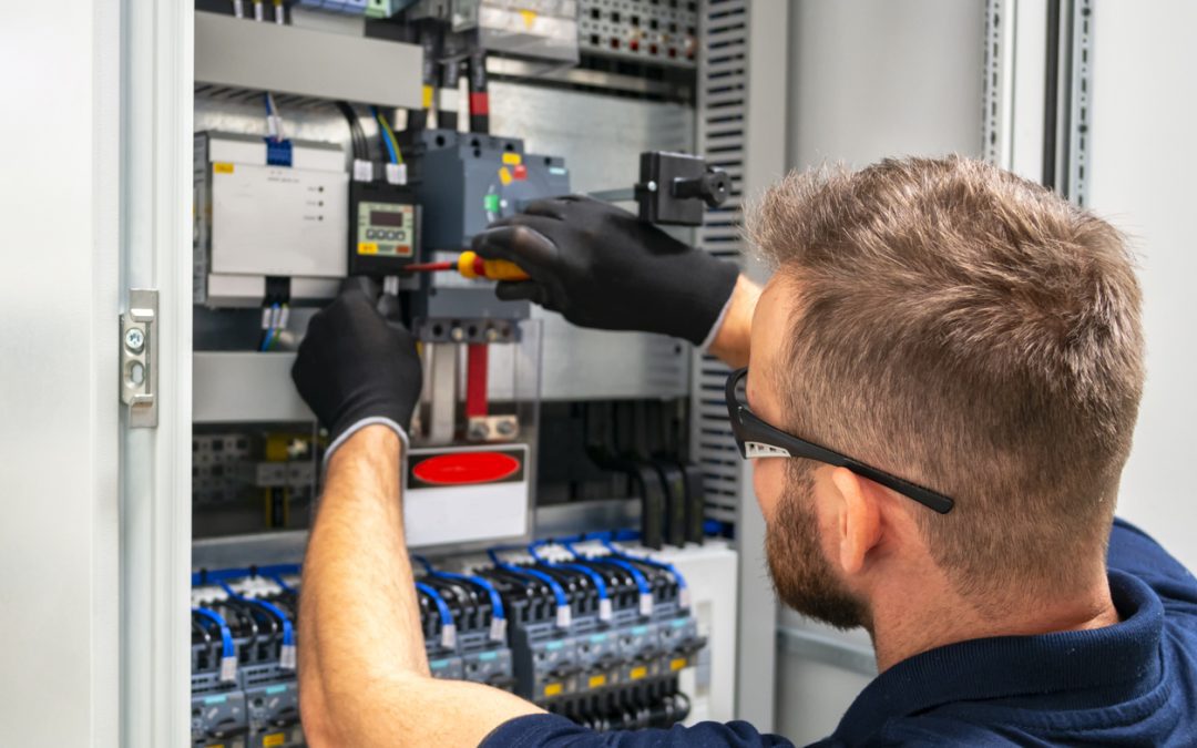 Electrician working at electric panel